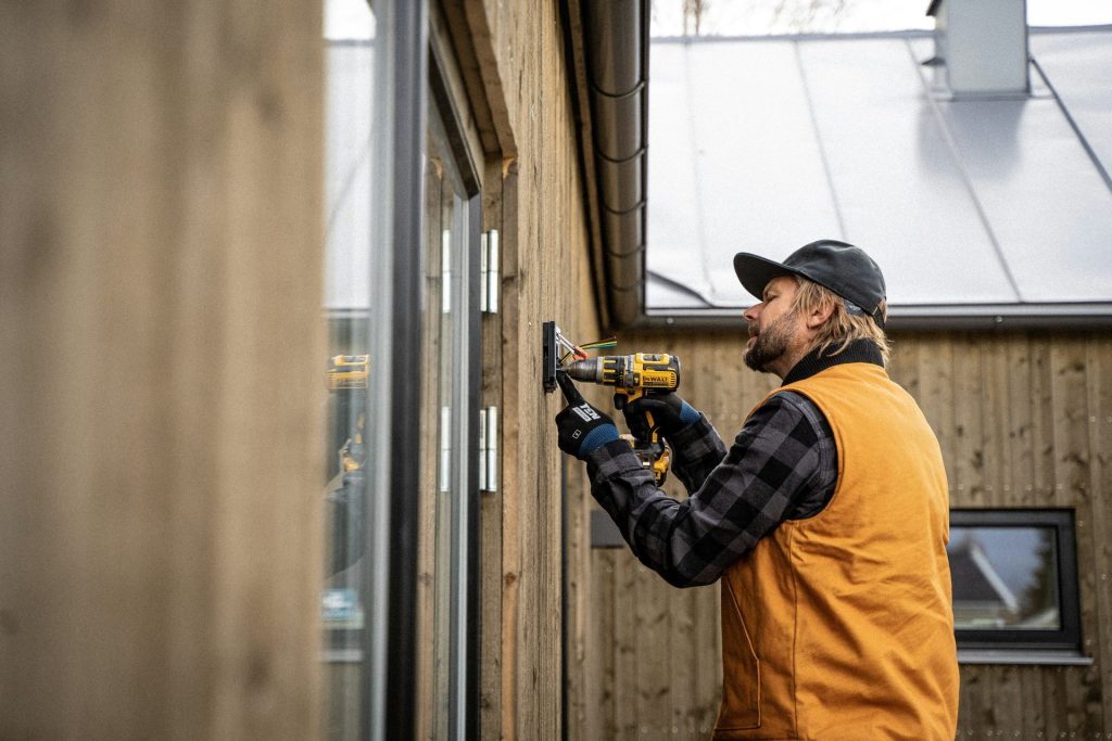 un homme avec une perceuse et un chapeau